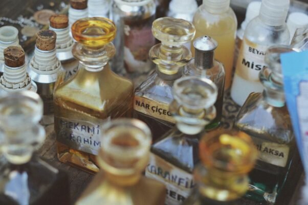 A row of glass perfume bottles on a light background